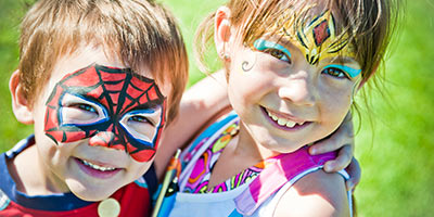 Children smiling with their faces painted