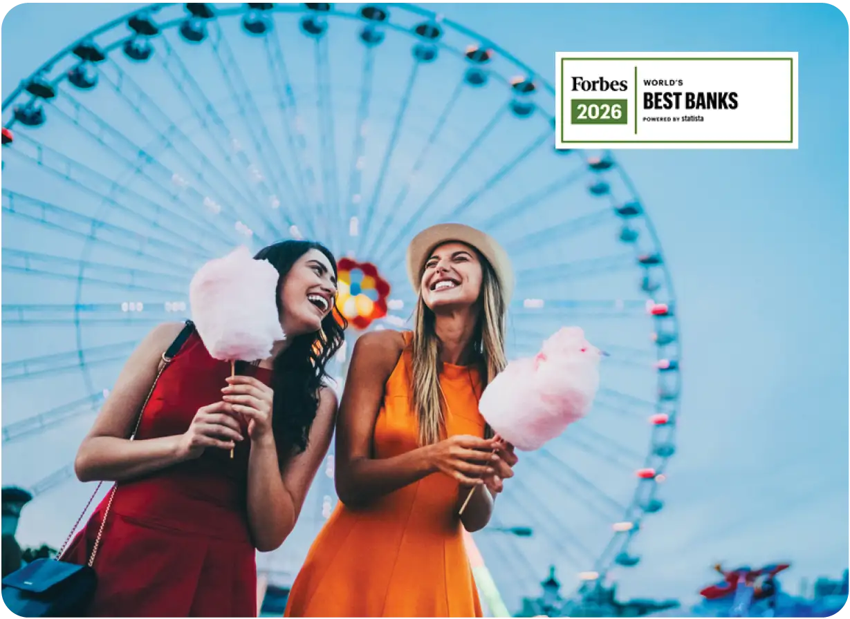 Two Young Women Eating Cotton Candy at Amusement Park