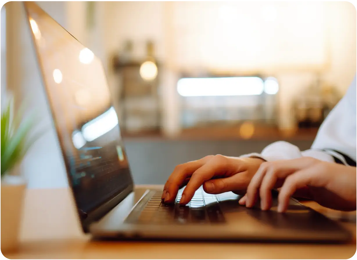 Fingers Typing on Laptop