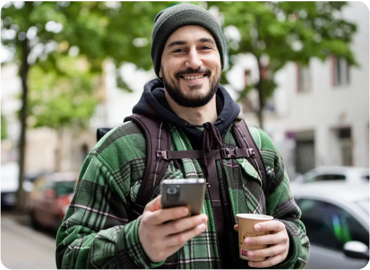 Man Holding Phone and Coffee