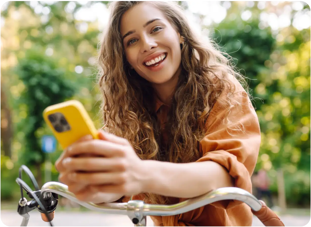 Woman on Bike Holding Phone
