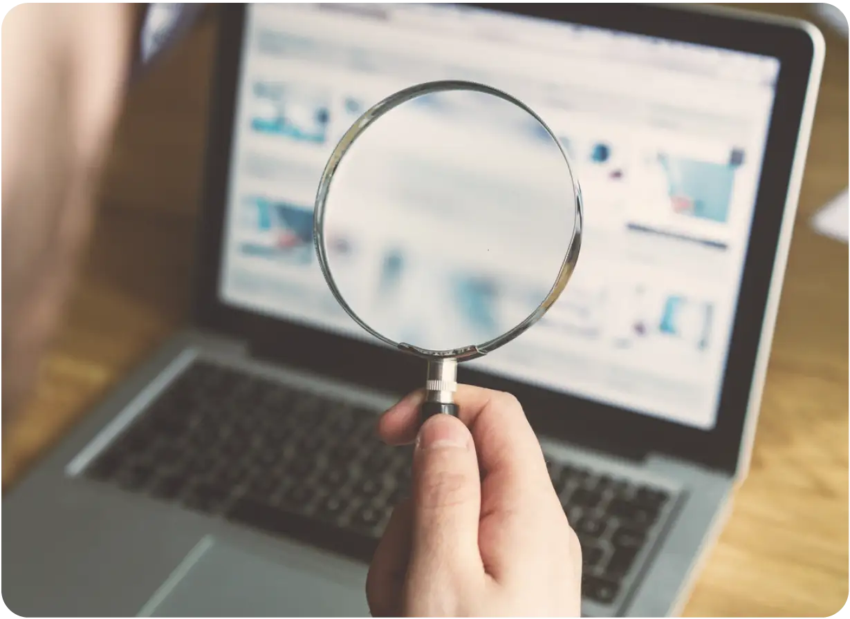 Magnifying Glass Over Computer Screen