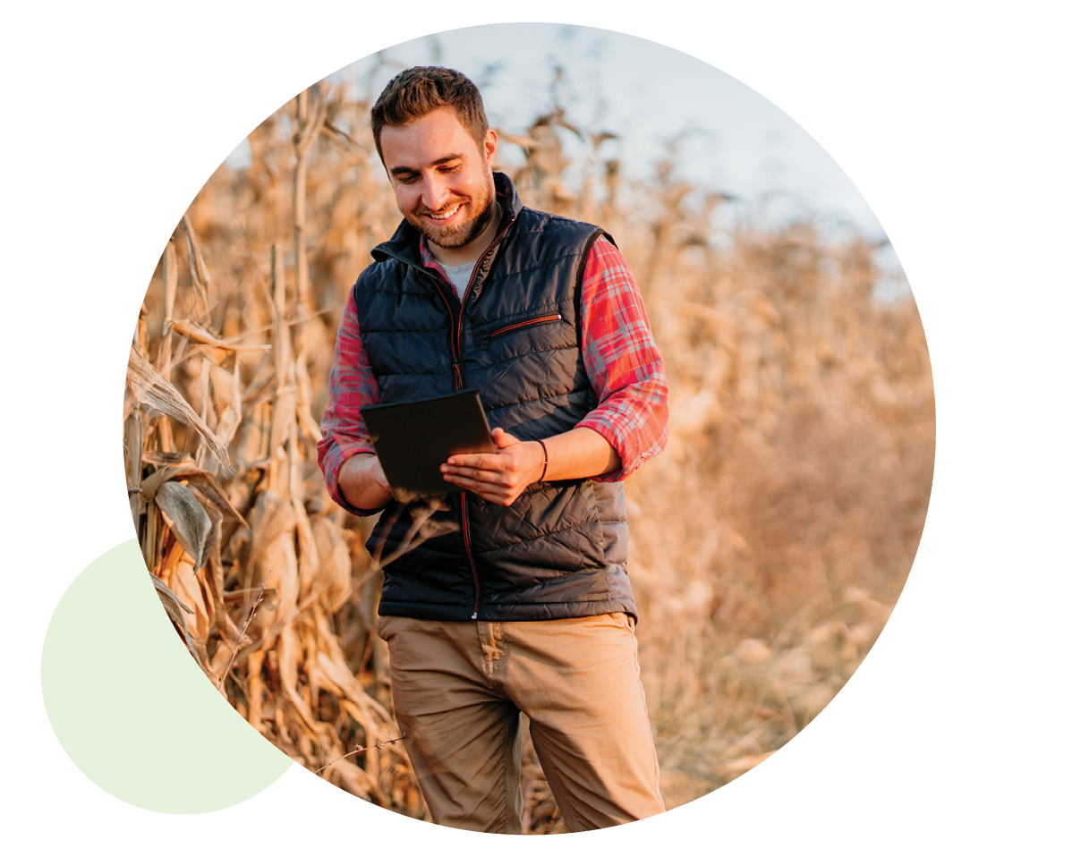 Farmer in field checking his tablet