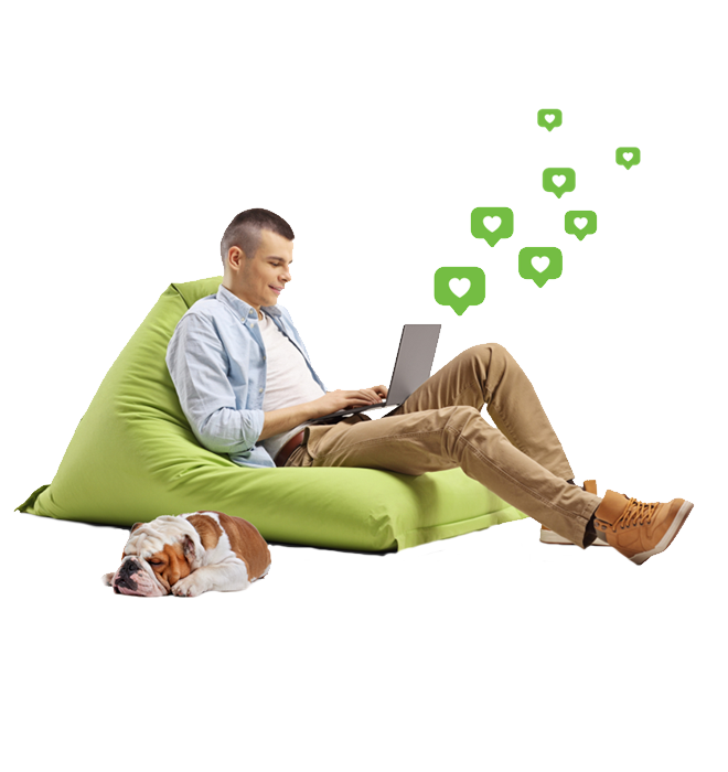 Man working on laptop lounging on beanbag chair