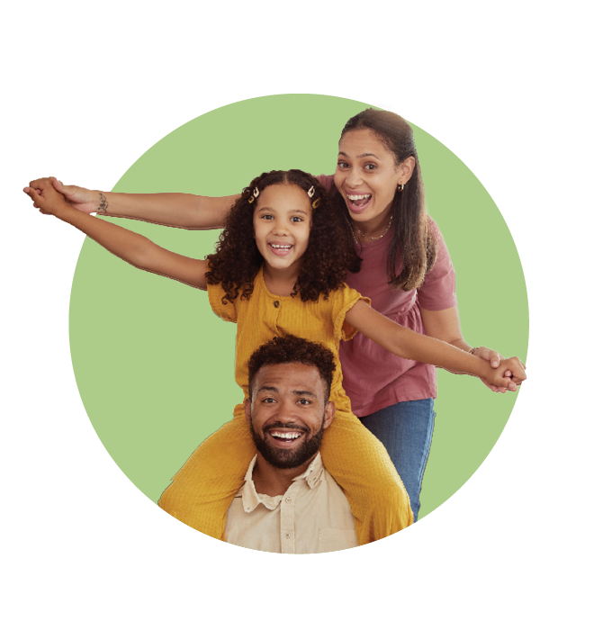 Happy family. Dad is giving daughter piggy-back ride with mom's help.