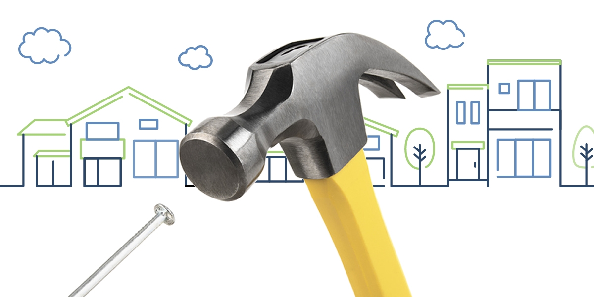 Hammer and nail with icon cityscape in the background