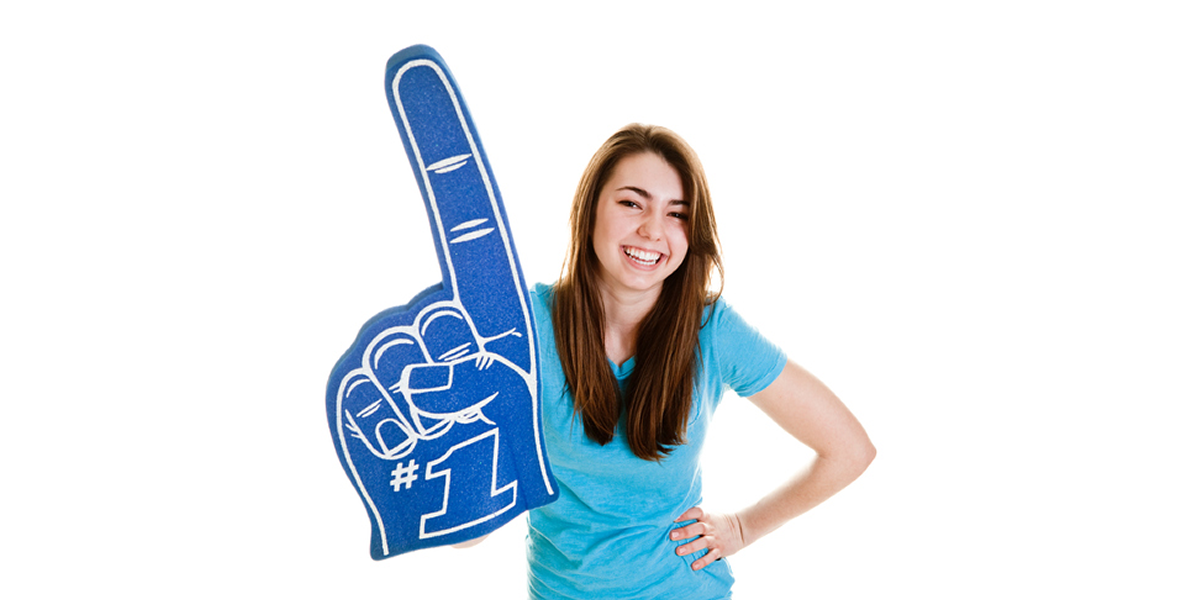 Happy female holding a foam finger with #1 on it