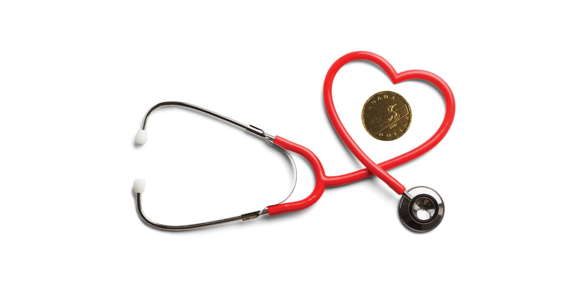 A stethoscope forming a heart around a Loonie.