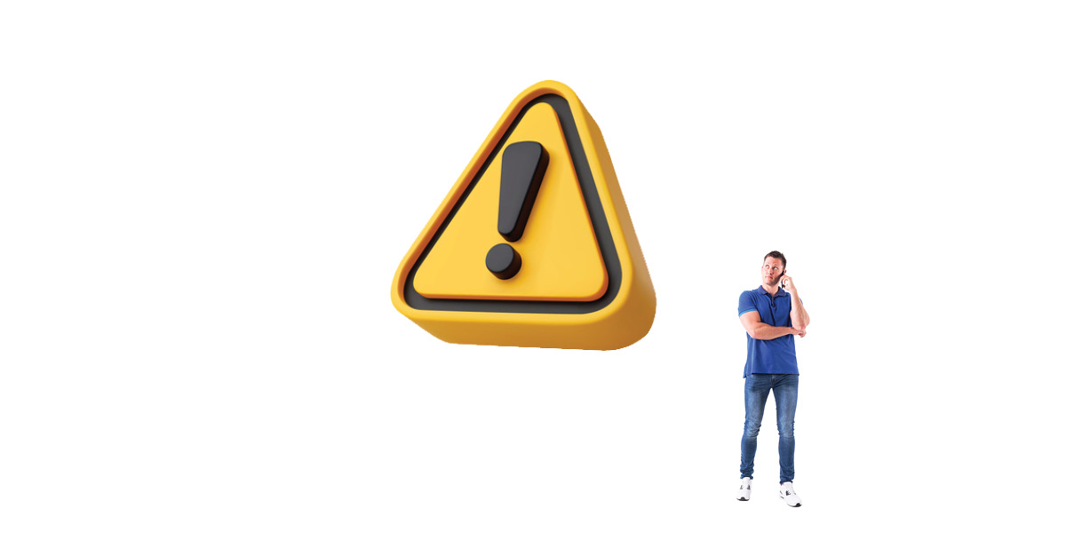 Man standing beside large caution sign