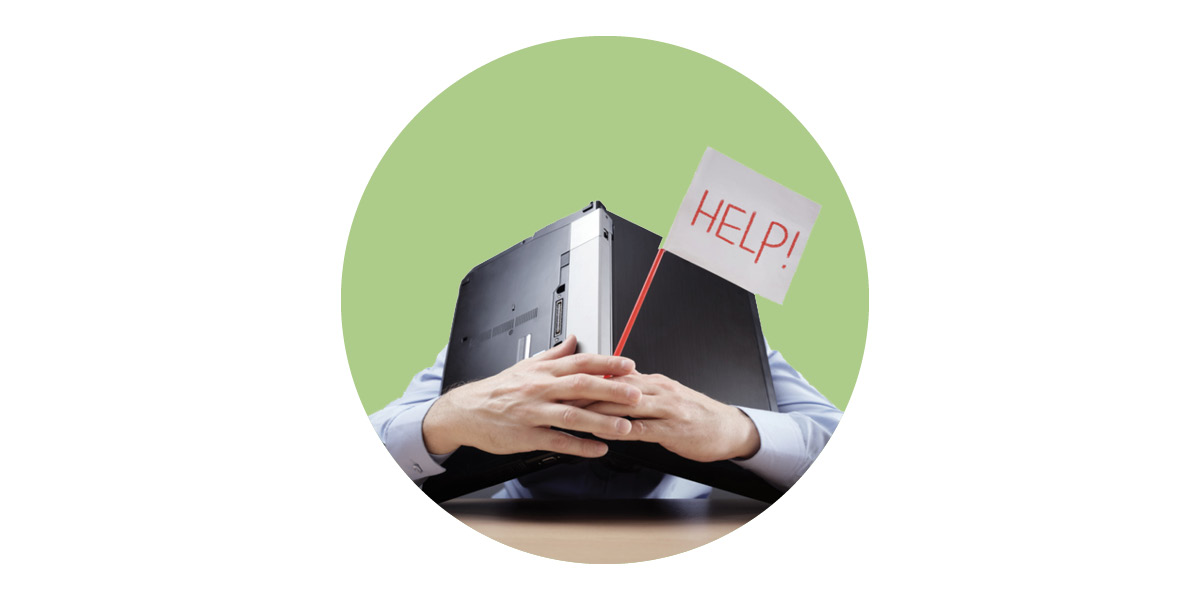 Man hiding behind laptop holding a help sign