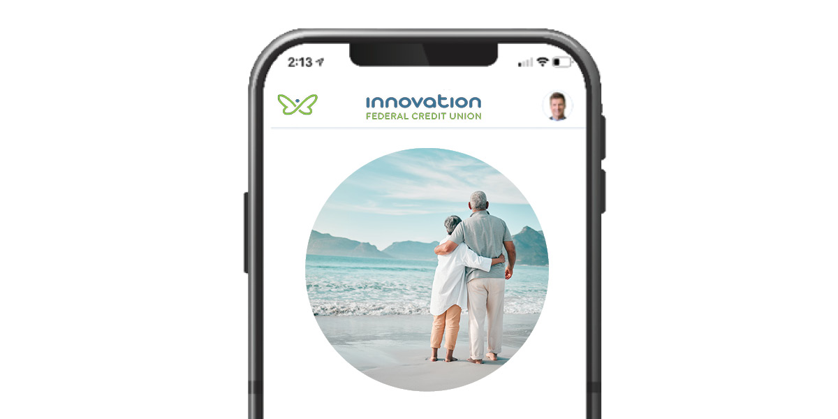 Mobile phone with image of retired couple on the beach