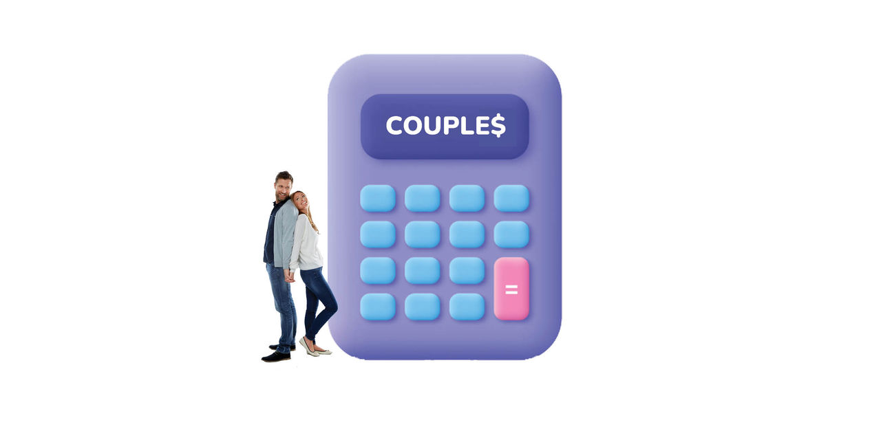 Couple standing beside large calculator