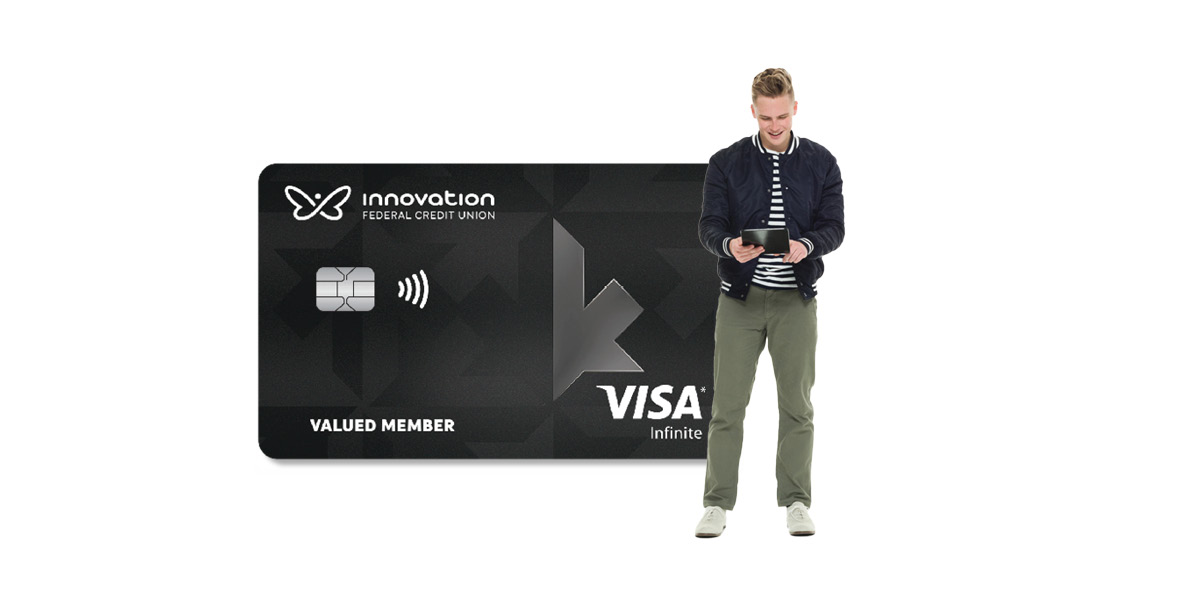 Man with calculator beside Visa card
