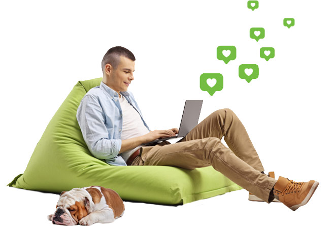 Young man using a laptop while sitting in a bean bag chair