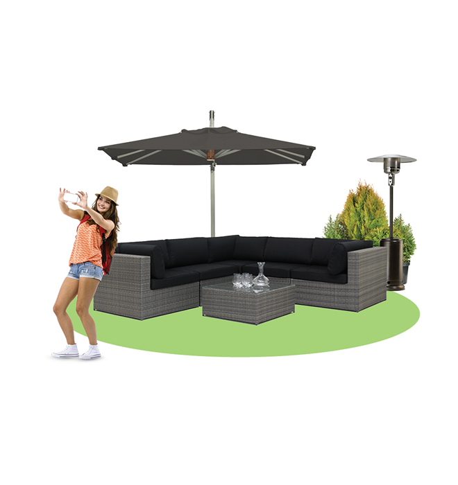 Happy female taking a photo in front of patio set