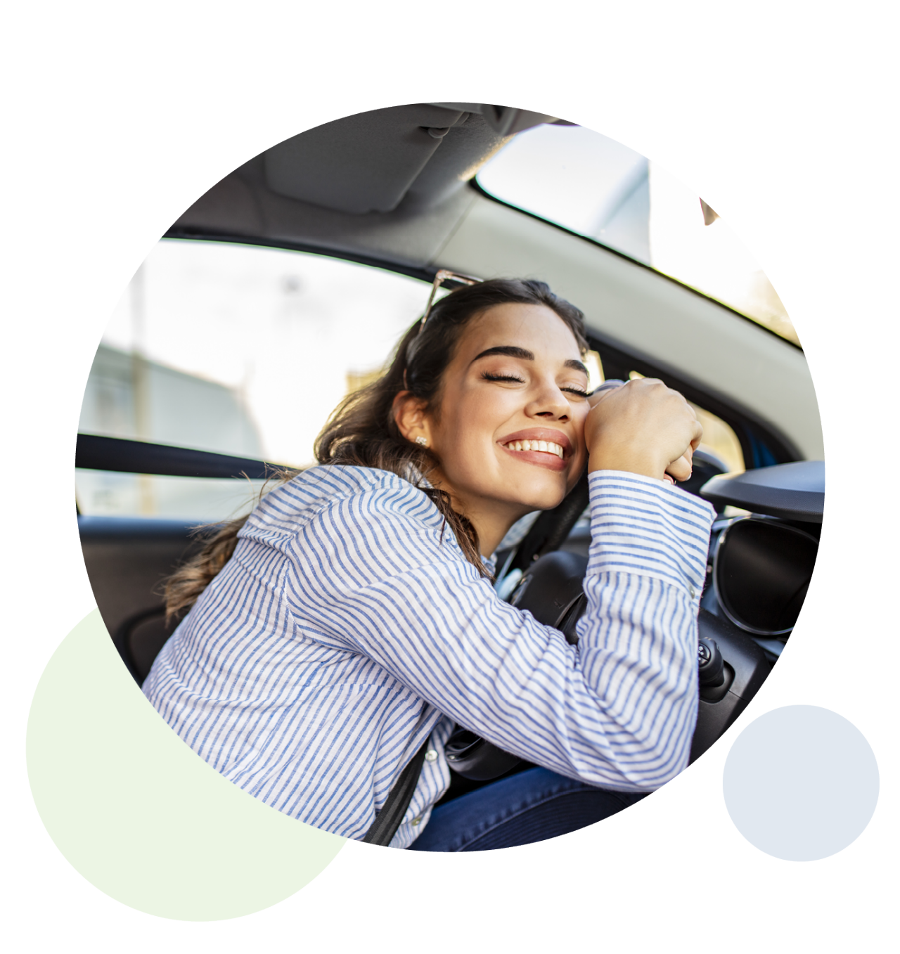 Happy woman hugging a car steering wheel