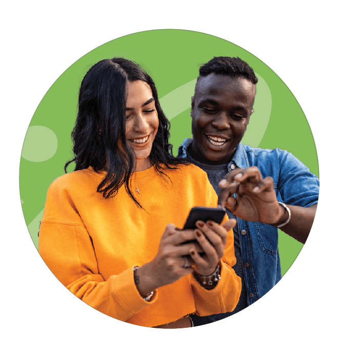 A couple looking happily at their mobile phone