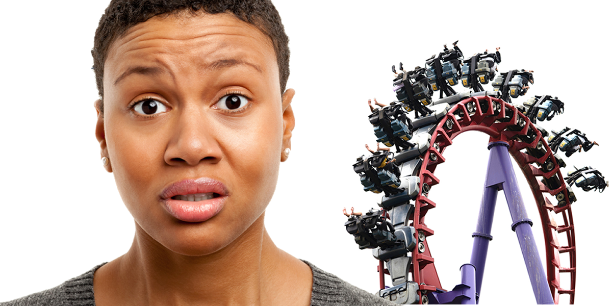 A frightened woman with a rollercoaster behind her